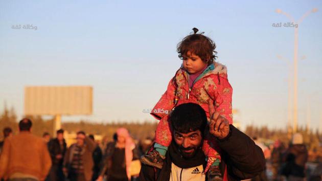 This image released by the Thiqa News Agency, shows a Syrian man carrying his daughter as they are evacuated from eastern Aleppo. (AP) This image released by the Thiqa News Agency, shows a Syrian man carrying his daughter as they are evacuated from eastern Aleppo. (AP)