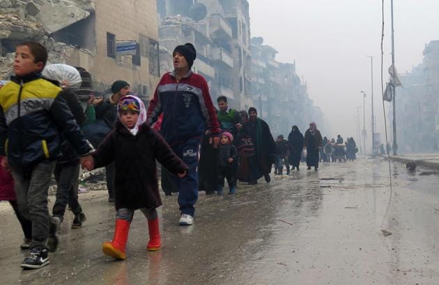 Syrian residents flee violence in the restive Bustan al-Qasr neighbourhood. (AFP)