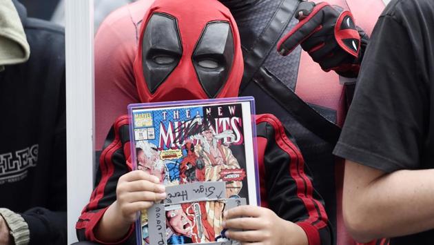 Allan Forte and his son Micah, 4, of San Bernardino, Calif., wear Deadpool costumes as they wait for actor Ryan Reynolds. (Chris Pizzello/Invision/AP)