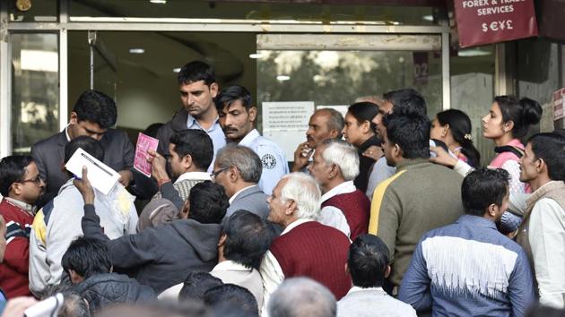 People wait in a queue outside Axis Bank at Stateman Building branch in Connaught Place to deposit and withdraw money. (Raj K Raj/HT Photo) People wait in a queue outside Axis Bank at Stateman Building branch in Connaught Place to deposit and withdraw money. (Raj K Raj/HT Photo)