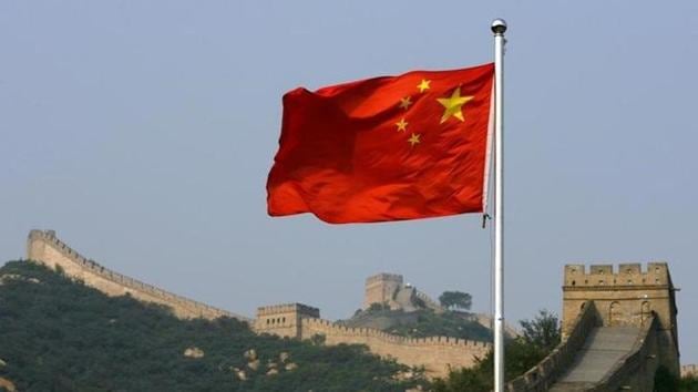 A Chinese flag flies in front of the Great Wall of China. (Reuters)