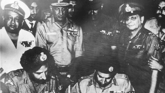 Lt. Gen JS Aurora, General Officer Commanding-in-Chief (GOC-in-C), eastern command, and Lieutenant General Amir Abdullah Khan Niazi of Pakistan army sign surrender documents on December 16, 1971. Vice-admiral N Krishnan, Air Marshal HC Dewan, Lt Gen Sagat Singh and Maj Gen JFR Jacob are also seen in the picture. (Photo division/defence wing)