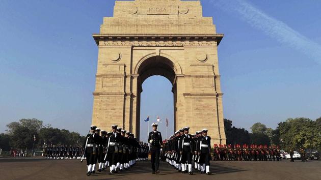 Soldiers pay homage to martyrs at 'Amar Jawan Jyoti' at India Gate on 'Vijay Diwas' in New Delhi on Friday. (PTI)