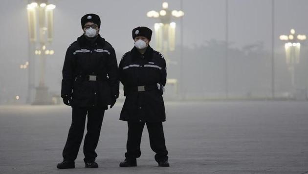 Policemen wear protective masks at the Tiananmen Square on an extremely polluted day as hazardous, choking smog continues to blanket Beijing, China on December 1.(Reuters)