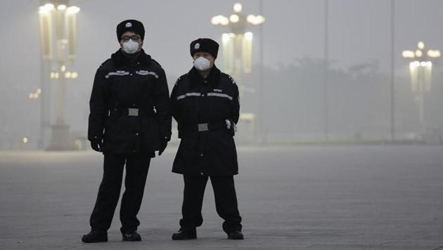Policemen wear protective masks at the Tiananmen Square on an extremely polluted day as hazardous, choking smog continues to blanket Beijing, China on December 1. (Reuters) Policemen wear protective masks at the Tiananmen Square on an extremely polluted day as hazardous, choking smog continues to blanket Beijing, China on December 1. (Reuters)