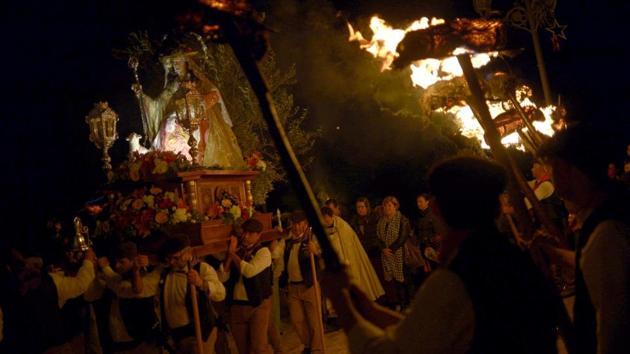Villagers carry a statue of the Virgin of Los Rondeles and hold torches during the Divina Pastora procession, to represent light and vision on the eve of St. Lucia's Day. (AFP) Villagers carry a statue of the Virgin of Los Rondeles and hold torches during the Divina Pastora procession, to represent light and vision on the eve of St. Lucia's Day. (AFP)