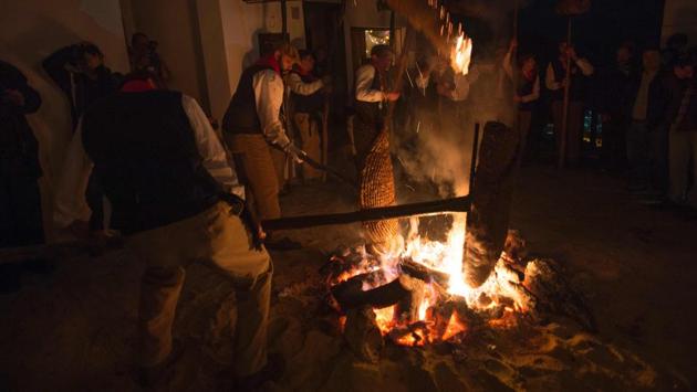 Participants use a bonfire to light their ‘rondeles’ (rolled wicker mats, soaked in oil) during the procession. (AFP) Participants use a bonfire to light their ‘rondeles’ (rolled wicker mats, soaked in oil) during the procession. (AFP)