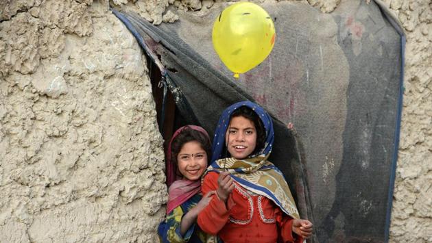 Internally displaced Afghan children play outside their temporary home at a refugee camp in Kabul on December 16. (NOORULLAH SHIRZADA / AFP) Internally displaced Afghan children play outside their temporary home at a refugee camp in Kabul on December 16. (NOORULLAH SHIRZADA / AFP)