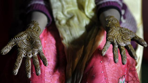 Brides get henna (mehndi) on their hands before the wedding. (Sunil Ghosh / HT photo) 