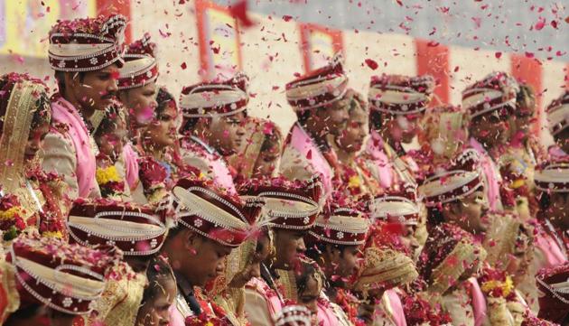 Seventy couples tied the knot in a mass wedding held in Noida Stadium. The entire event was cashless as all contributions were made by the entrepreneurs in goods. (Burhaan kinu/ht photo)
