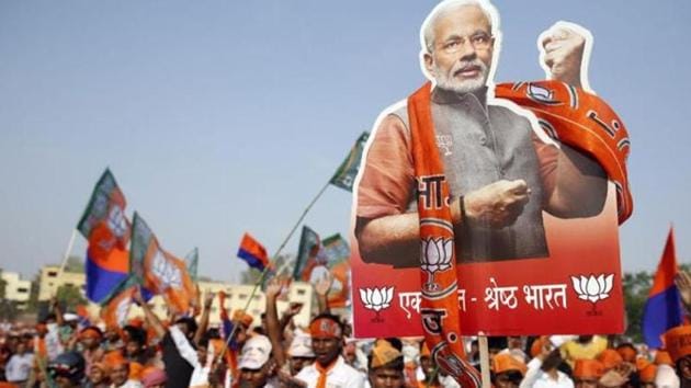 A supporter of Bharatiya Janata Party holds up a cutout of the party's prime ministerial candidate Narendra Modi during an election campaign rally in Varanasi, in Uttar Pradesh. (AP File Photo) A supporter of Bharatiya Janata Party holds up a cutout of the party's prime ministerial candidate Narendra Modi during an election campaign rally in Varanasi, in Uttar Pradesh. (AP File Photo)