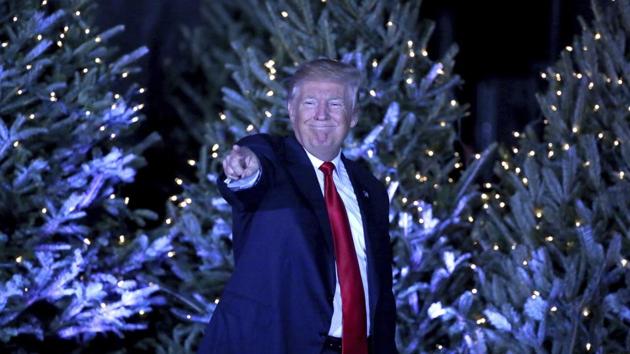 President-elect Donald Trump points to cheering supporters, in front of a backdrop of Christmas trees, at a rally in Orlando on Dec 16. (AP Photo) President-elect Donald Trump points to cheering supporters, in front of a backdrop of Christmas trees, at a rally in Orlando on Dec 16. (AP Photo)
