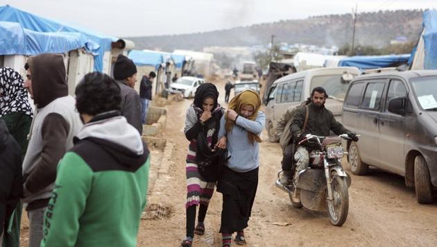 Syrians, evacuated from Aleppo, walk in a refugee camp near Idlib, Syria on Dec 16. (AP Photo) Syrians, evacuated from Aleppo, walk in a refugee camp near Idlib, Syria on Dec 16. (AP Photo)
