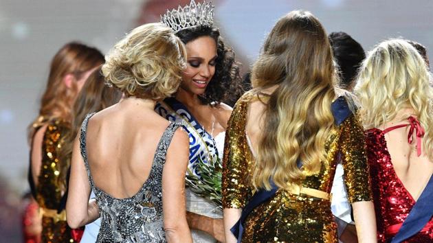 Newly elected Miss France 2017 Alicia Aylies (second from left) being congratulated by Miss France Society President and Miss France 2002 Sylvie Tellier (left) and the contestants after winning the title.  (AFP) 