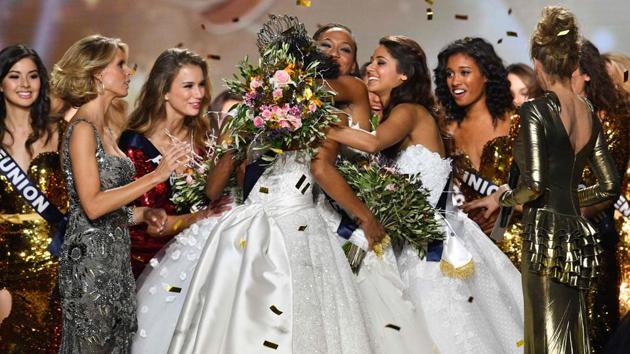Alicia Aylies (centre) being congratulated by fellow contestants after winning the title.  (AFP) 