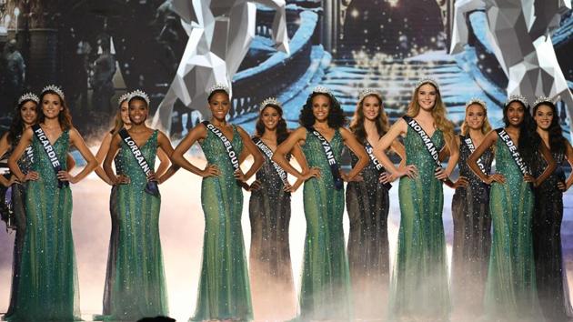 Contestants pose on stage during the competition.  (AFP) 