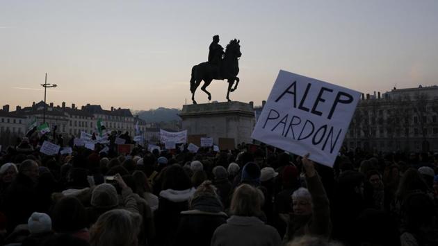 A placard reading 'Aleppo forgive us' is seen during a demonstration to protest against the war and the humanitarian crisis in Aleppo, in Lyon, central France. (Laurent Cipriani/AP Photo) 
