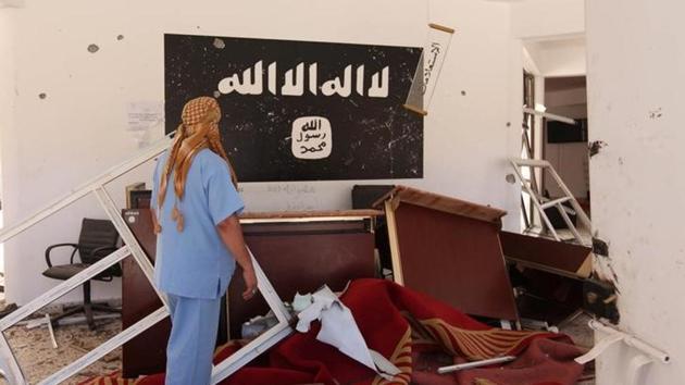 A man checks a building used by the Islamic State fighters after it was captured by Libyan forces allied with the UN-backed government, in Sirte, Libya. (Reuters File Photo) A man checks a building used by the Islamic State fighters after it was captured by Libyan forces allied with the UN-backed government, in Sirte, Libya. (Reuters File Photo)