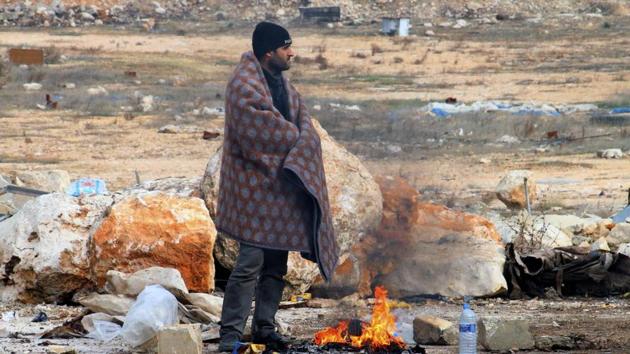 This image released by Aleppo 24, shows a man standing next to a fire in western rural Aleppo, Syria. As the last holdouts leave the rebel-held enclave in Aleppo, they speak of their love for the city despite witnessing so much destruction and death. Bit by bit over three weeks, the government offensive chipped away at their last refuge. (AP Photo) This image released by Aleppo 24, shows a man standing next to a fire in western rural Aleppo, Syria. As the last holdouts leave the rebel-held enclave in Aleppo, they speak of their love for the city despite witnessing so much destruction and death. Bit by bit over three weeks, the government offensive chipped away at their last refuge. (AP Photo)