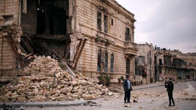 People take pictures in front of the old Customs building in the government controlled Old City of Aleppo, Syria. People take pictures in front of the old Customs building in the government controlled Old City of Aleppo, Syria.