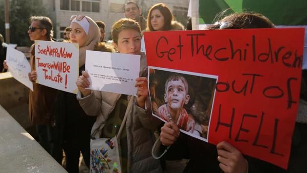Protesters take part during a sit-in, in solidarity with the people of Aleppo against the Syrian regime, in front of the UNDP office in Amman, Jordan. (Muhammad Hamed/Reuters Photo) 