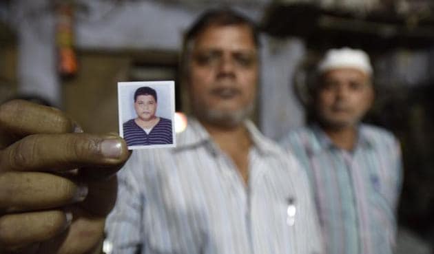 A relative shows a passport-size photo of Saur-ur-Rehman who died in a queue before a bank in Old Delhi area on November 16. (HT Photo) A relative shows a passport-size photo of Saur-ur-Rehman who died in a queue before a bank in Old Delhi area on November 16. (HT Photo)