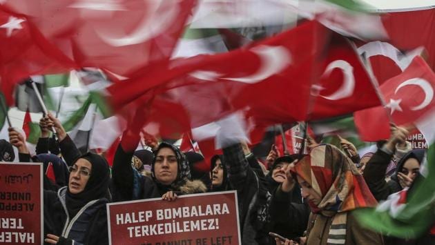 Supporters of a pro-Islamic group stage a protest against the war in Aleppo, at the Bab al-Hawa border crossing with Syria near the southeastern city of Hatay, Turkey.  (Emrah Gurel/AP Photo) 