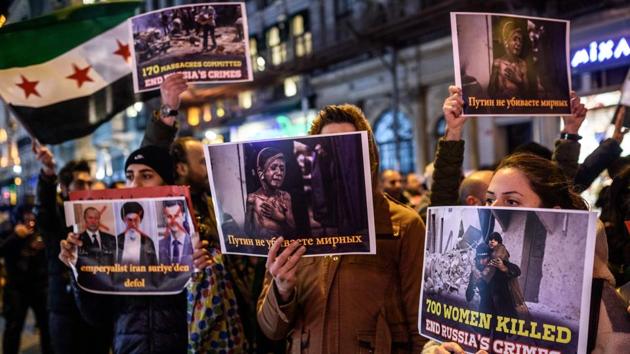 Syrians living in Turkey hold signs during a protest against Russia, Syrian president Bashar al-Assad's regime ally, in front of the Russian Embassy along Istiklal Avenue in Istanbul. (Ozan Kose/AFP Photo) 
