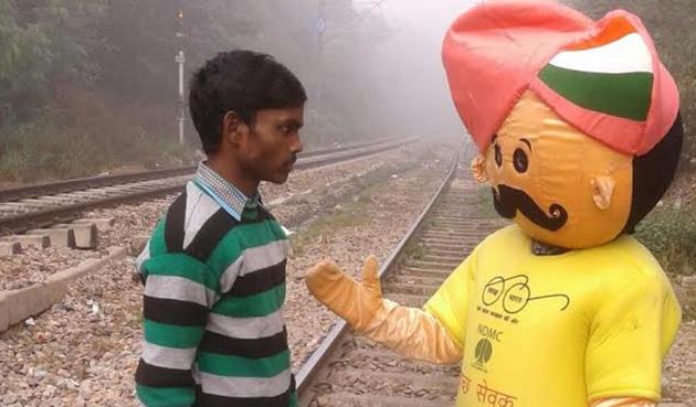 A ‘swachh sewak’ of the New Delhi Municipal Council stops a man from defecating in the open. (Handout) A ‘swachh sewak’ of the New Delhi Municipal Council stops a man from defecating in the open. (Handout)