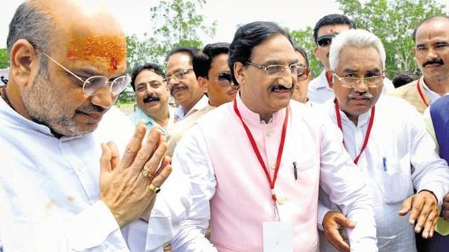 BJP president Amit Shah being welcomed by party MP Ramesh Pokhriyal Nishank (C) and MLA Madan Kaushik (R) in Haridwar on Jun 26, this year.(Ravinder Kumar /HT FILE) BJP president Amit Shah being welcomed by party MP Ramesh Pokhriyal Nishank (C) and MLA Madan Kaushik (R) in Haridwar on Jun 26, this year.(Ravinder Kumar /HT FILE)