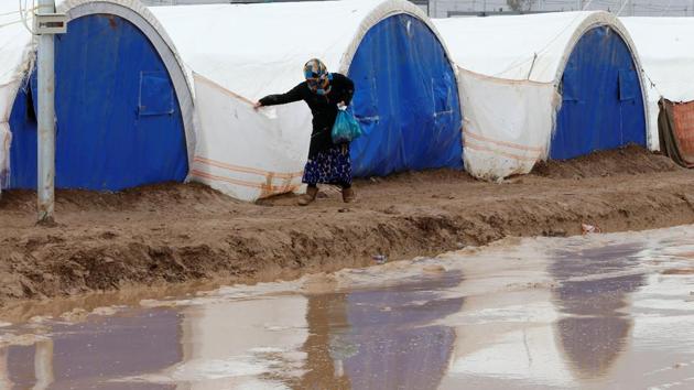 Heavy rain flooded the Khazer camp on Monday. As winter creeps in, the days at the camp are getting chilly. (Ammar Awad / REUTERS)