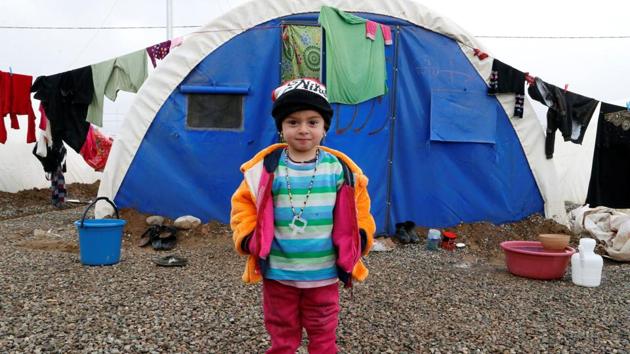Saada Ahmed, a 3-year-old Iraqi boy who fled the Islamic State stronghold of Mosul, outside a tent at Khazer camp. (Ammar Awad / REUTERS)
