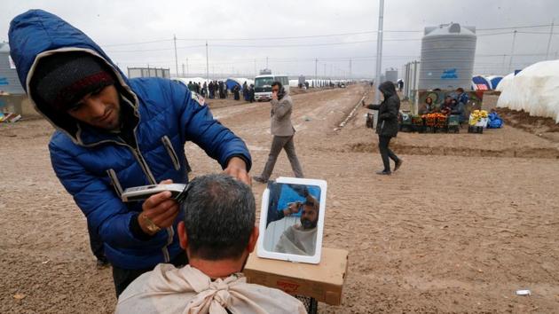 A man gets a haircut at Khazer camp, Iraq. Many of the displaced anticipate that their stay at the camp may be prolonged if the fight against Islamic State rages on. (Ammar Awad / REUTERS)