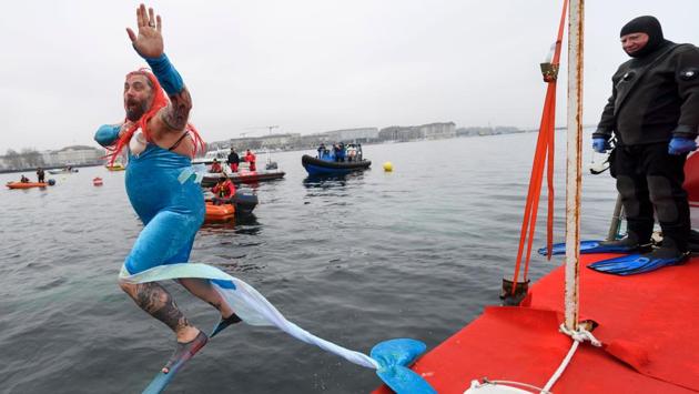 A man disguised as a mermaid jumps into the water. (Fabrice Coffrini/AFP) A man disguised as a mermaid jumps into the water. (Fabrice Coffrini/AFP)