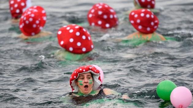 A disguised woman swims during the 78th "Coupe de Noel" (Christmas cup) swimming race in the Lake Geneva. (Fabrice Coffrini/AFP) A disguised woman swims during the 78th "Coupe de Noel" (Christmas cup) swimming race in the Lake Geneva. (Fabrice Coffrini/AFP)