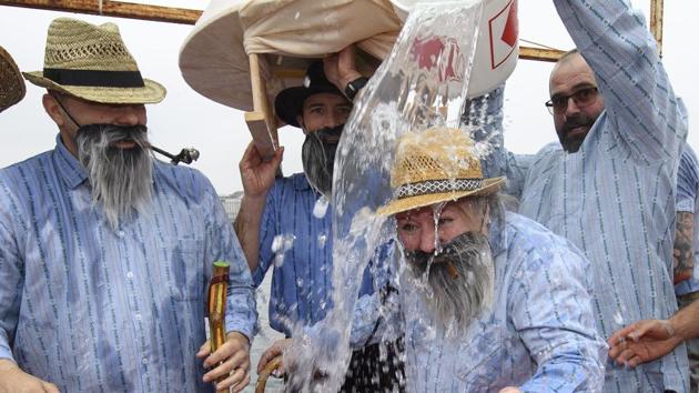 Participants celebrate by splashing cold water on each other before jumping into the Lake Geneva. (Martial Trezzini/AP) Participants celebrate by splashing cold water on each other before jumping into the Lake Geneva. (Martial Trezzini/AP)