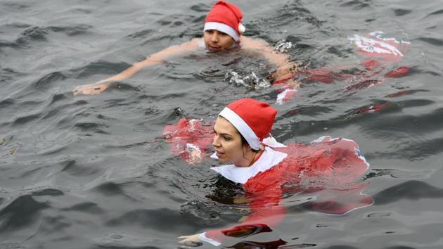 Participants dressed as Santa swim in Lake Geneva. (Martial Trezzini/AP) Participants dressed as Santa swim in Lake Geneva. (Martial Trezzini/AP)