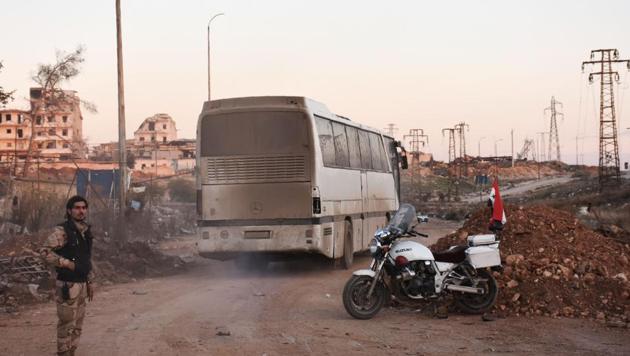 A bus drives through the Syrian government-controlled crossing of Ramoussa, on the southern outskirts of Aleppo. (AFP) A bus drives through the Syrian government-controlled crossing of Ramoussa, on the southern outskirts of Aleppo. (AFP)