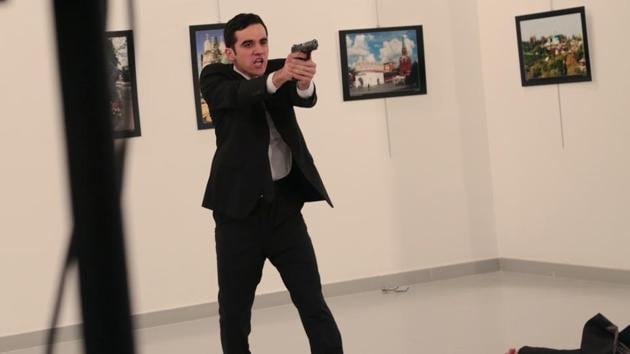 An unnamed gunman gestures after shooting the Russian Ambassador to Turkey, Andrei Karlov, at a photo gallery in Ankar.(AP) An unnamed gunman gestures after shooting the Russian Ambassador to Turkey, Andrei Karlov, at a photo gallery in Ankar.(AP)
