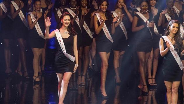 Miss China Jing Kong (L) waves as she walks up the stage during pageant. (Zach Gibson/AFP)