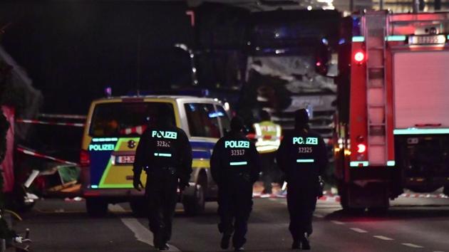 Police walk before the truck that had sped into a Christmas market in Berlin, on Monday, killing twelve people and injuring dozens more. (AFP) Police walk before the truck that had sped into a Christmas market in Berlin, on Monday, killing twelve people and injuring dozens more. (AFP)