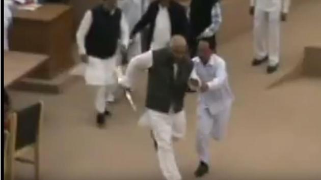 TMC MLA Sudip Roy Barman seized the speaker’s mace and ran away with it outside the house abruptly putting a halt to the proceedings. (YouTube screengrab) TMC MLA Sudip Roy Barman seized the speaker’s mace and ran away with it outside the house abruptly putting a halt to the proceedings. (YouTube screengrab)