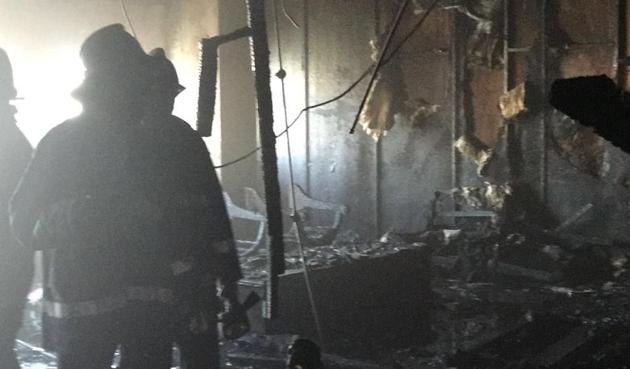 Fire fighters inspect the charred remains on the 22nd floor of the Air India building, Nariman Point, in South Mumbai on Tuesday.(HT)