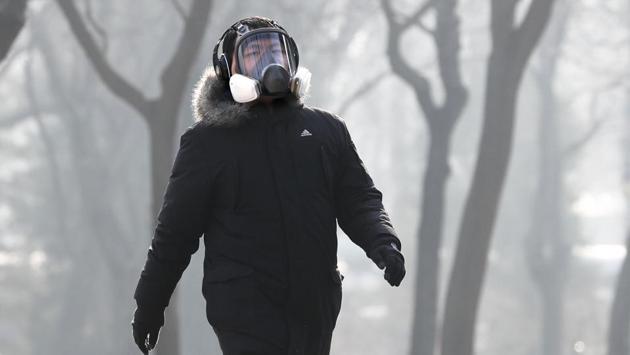 A man wearing a mask exercises at Ritan Park in Beijing. (AP photo) A man wearing a mask exercises at Ritan Park in Beijing. (AP photo)