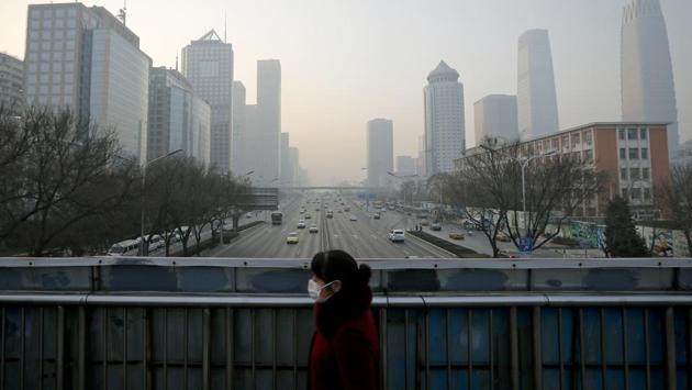 A woman walks on a pedestrian overhead bridge in Beijing. More than 700 companies stopped production in Beijing and traffic police were restricting drivers by monitoring their license plate numbers. (AP photo) A woman walks on a pedestrian overhead bridge in Beijing. More than 700 companies stopped production in Beijing and traffic police were restricting drivers by monitoring their license plate numbers. (AP photo)