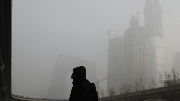 A man wears a mask as Beijing is engulfed in smog. In choking conditions, dozens of cities closed schools and took other emergency measures after the alert was issued for much of northern China. (AP photo) A man wears a mask as Beijing is engulfed in smog. In choking conditions, dozens of cities closed schools and took other emergency measures after the alert was issued for much of northern China. (AP photo)