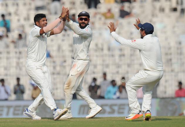 India's Umesh Yadav (L) celebrates the wicket of England's Adil Rashid along with captain Virat Kohli on Day 5 in Chennai.(AFP)