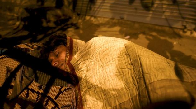 A man sleeps on a footpath near Byculla station in Mumbai. (Pratik Chorge/HT PHOTO)