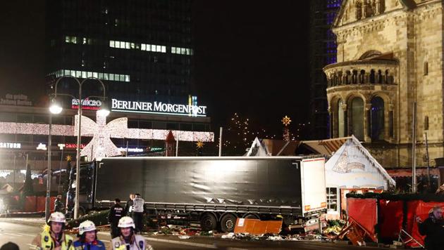 Police and firefighters work around the truck that crashed into a Christmas market at Ged?chniskirche church in Berlin.(AFP Photo)