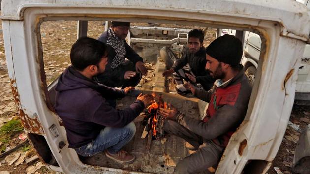 People light a fire to warm themselves on a cold day in Srinagar. (Reuters photo) People light a fire to warm themselves on a cold day in Srinagar. (Reuters photo)